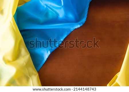 Ukraine flag on wooden table background