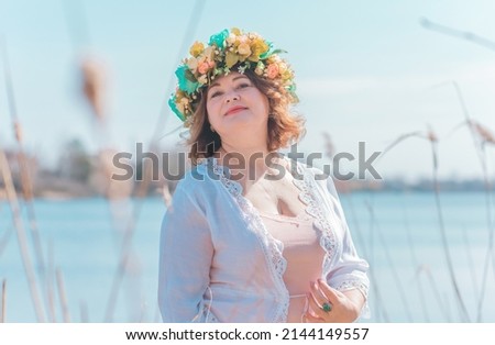 Sunny nice Boho ethic style for ladies. Plus size European in floral wreath, model in natural clothes, fashion concept