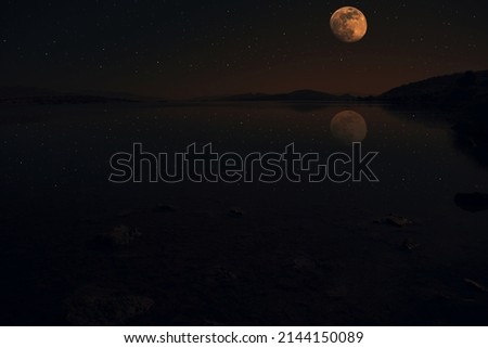 Stars and moon reflection on lake  