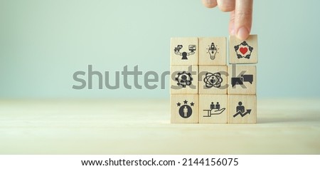 Employee engagement and team motivation. Productive people, inspiration. Common goals of the company and employees for sustainability. Putting  wooden cubes engagement icon with the ways of building. Royalty-Free Stock Photo #2144156075