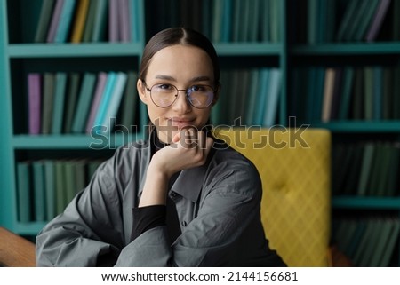Portrait of a consultant woman with glasses working in an office, workplace coworking space