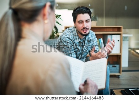 Sometimes I feel like.... Shot of a young man having a therapeutic session with a psychologist and looking upset. Royalty-Free Stock Photo #2144164483