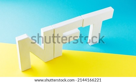 NFT inscription with white 3d letters on a blue-yellow background. Non-fungible token against background of colors of the Ukrainian flag. Crypto art concept