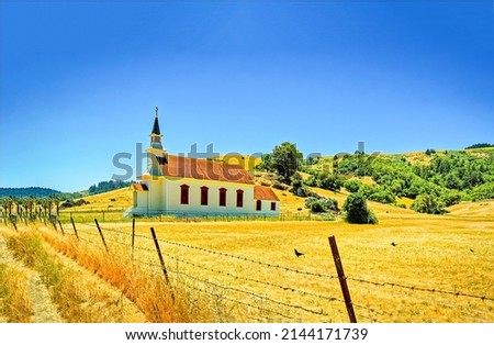 Rural church on a country field. Rural church landmark. Church in sunny day on countryside landscape. Wooden church on rural landscape Royalty-Free Stock Photo #2144171739