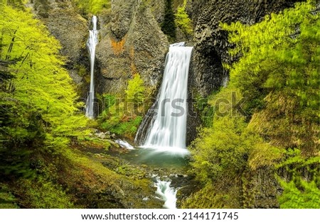 Waterfall in the depths of the forest. Mountain waterfall cascade in autumn forest. Waterfall cascade on rock. Autumn forest waterfall cascade landscape Royalty-Free Stock Photo #2144171745
