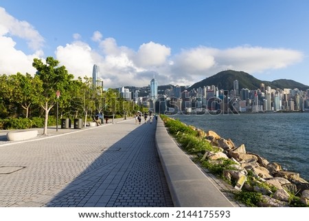 spacial walking area in West Kowloon Waterfront Promenade along Victoria Harbour on reclaimed land in Tsim Sha Tsui on the Kowloon peninsula of Hong Kong. Buildings in HK Island in background Royalty-Free Stock Photo #2144175593