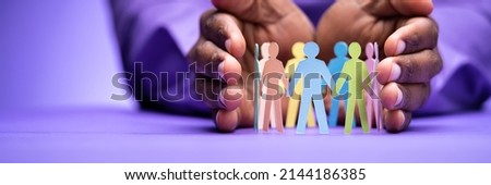 Inclusion, Diversity And Equality. African Hands Safeguard Paper Shapes Royalty-Free Stock Photo #2144186385