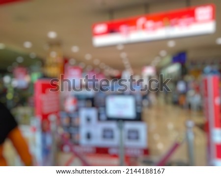 Defocused abstract background front view of the store inside modern shopping mall.