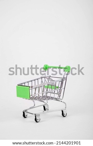 Empty shopping cart on wheels on a white isolated background and copy space.