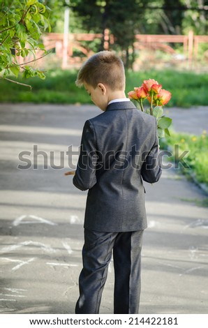 boy with a bouquet of flowers waiting for a girl on a date