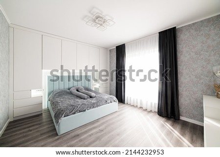 Large, designer bed in the center of the room. Place to relax