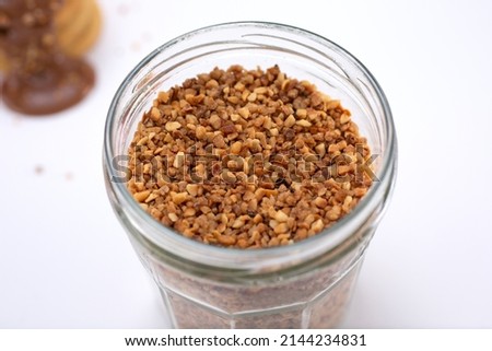 A view of a jar of crushed peanuts.