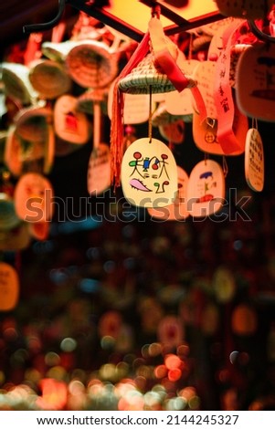 Wooden blessing cardswith colorful painting hung high for praying good luck in chinese tourist attractions. Decorations for new year or valentine's day.