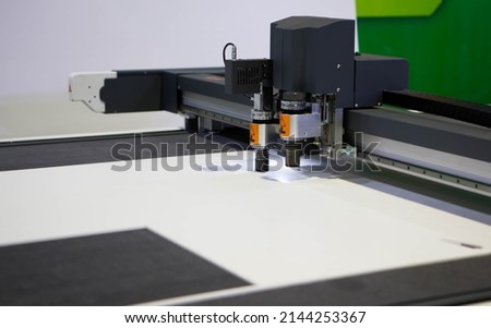 Digital die cutter machine cutting PP flute board. Industrial manufacture. Royalty-Free Stock Photo #2144253367
