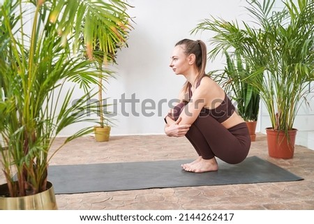 Young woman going yoga table exercise at home. Health care online lessons. Indoor fitness workout. Remote sport trainer. Morning activity. Floor pilates mat. Female person lifestyle. Asana pose