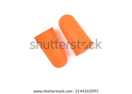 Two soft orange foam earplugs isolated on a white background.Close-up.The concept of getting rid of noise in a loud place, hearing protection.High quality photo