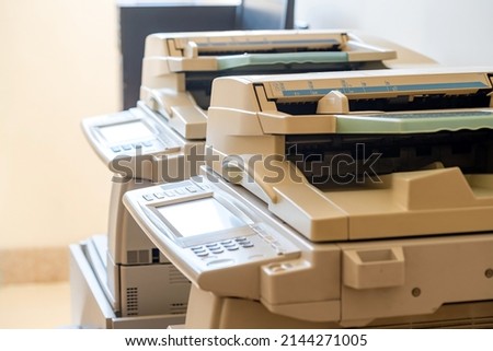 Copy shop copiers, photocopying point interior, two photocopiers copy machines objects closeup, detail, nobody. Photocopy archiving, scanning copying documents technology abstract concept, no people Royalty-Free Stock Photo #2144271005