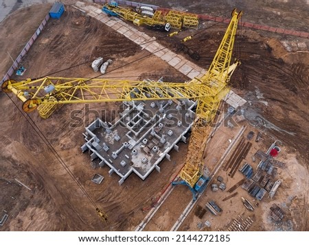Tower crane at the construction site.Building construction.The foundation for the construction of the building has begun. Construction concept.Aerial view. High quality photo