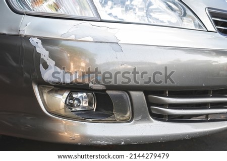 Close-up of damaged fog lights lens  ,Cracked and peeling paint on car front bumper. Royalty-Free Stock Photo #2144279479