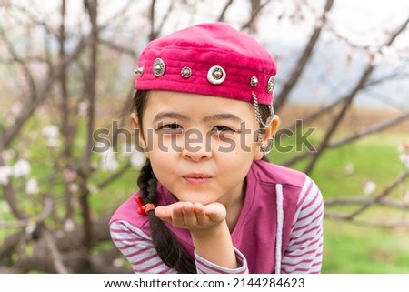 girl in a national headdress. Spring, Nowruz holiday. Kazakh girl. Central Asia, Kazakhstan. Royalty-Free Stock Photo #2144284623