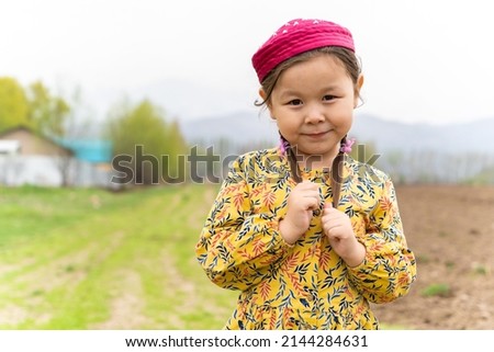 girl in a national headdress. Spring, Nowruz holiday. Kazakh girl. Central Asia, Kazakhstan. Royalty-Free Stock Photo #2144284631