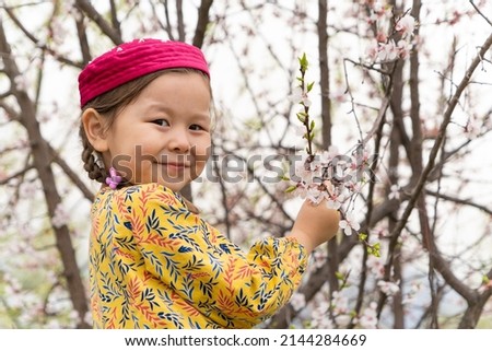girl in a national headdress. Spring, Nowruz holiday. Kazakh girl. Central Asia, Kazakhstan. Royalty-Free Stock Photo #2144284669