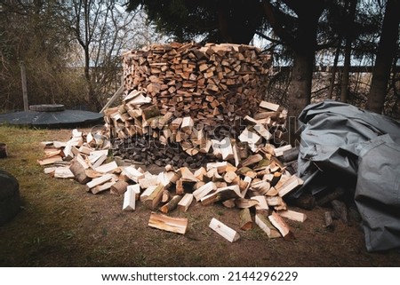 chopped wood is stacked into a large round cylinder