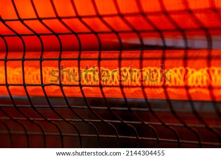 Side view electric heater working in dark space