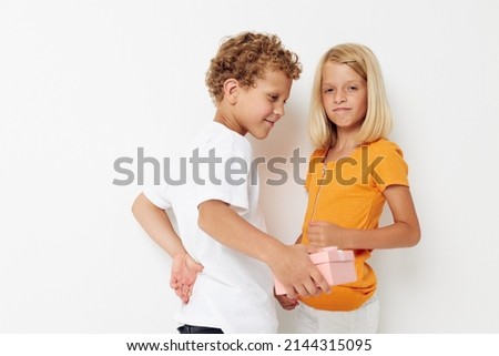 picture of positive boy and girl fun birthday gift surprise isolated background unaltered