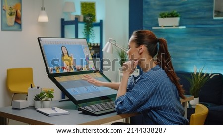 Retouch specialist doing editing work on pictures in office studio. Graphic artist using retoucing software on monitor with touch screen for photography project. Professional media editor