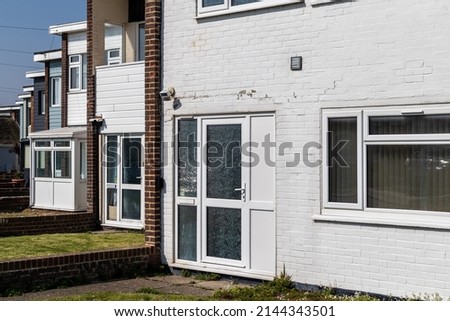 Row of 1960s terraced homes featuring flat roofs Royalty-Free Stock Photo #2144343501