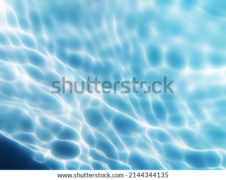 Closeup​ blur​ abstract​ of​ surface​ blue​ water. Abstract​ of​ surface​ blue​ water​ reflected​ with​ sunlight​ for​ background.Top​ view​ of blue​ water.​ Water​ splashed​ use​ for​ graphic​ art.