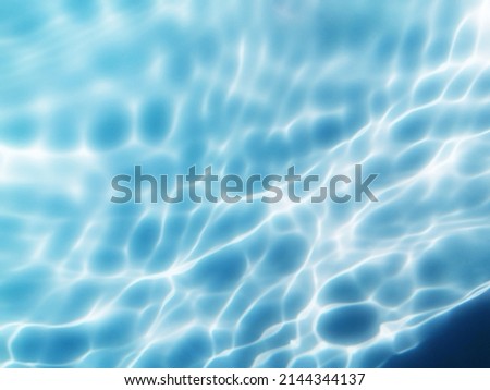 Closeup​ blur​ abstract​ of​ surface​ blue​ water. Abstract​ of​ surface​ blue​ water​ reflected​ with​ sunlight​ for​ background.Top​ view​ of blue​ water.​ Water​ splashed​ use​ for​ graphic​ art.