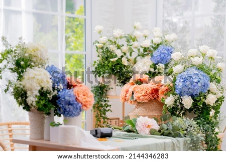 floral flower bouquet business shop,beaufiful fresh flower hydrangea white rose and natural basket arrange with order on table in flower small business shop morning light Royalty-Free Stock Photo #2144346283