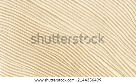 Aesthetic geometric pattern on sand, beautiful sandy waves texture, Spa background, concept of harmony, balance and meditation, relaxation. Top view textured fine sand, natural abstract ornament
