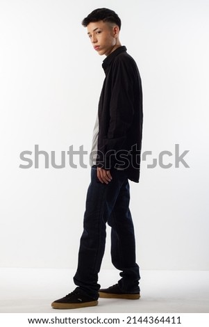 Young man in formal clothes for editorial photography with a white background and recreating different poses