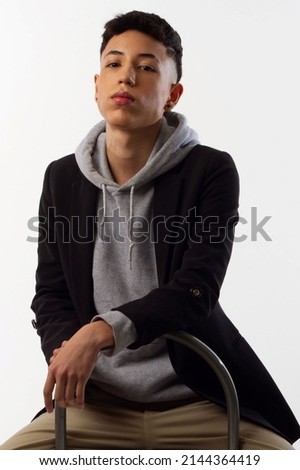 Young man in formal clothes for editorial photography with a white background and recreating different poses