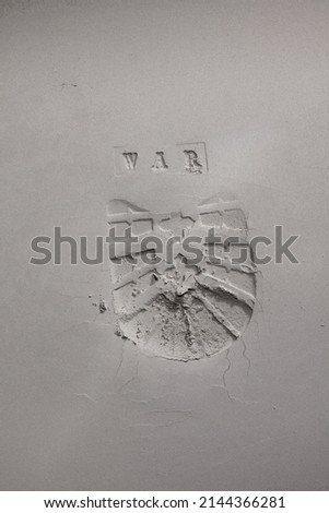 Print from military boots with "WAR" embossing on a gray background