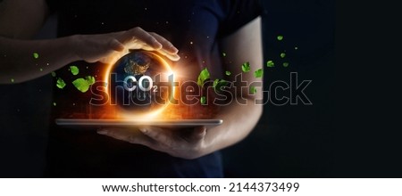 Man hold earth energy at night on tablet depicting the issue and reduce CO2 emissions carbon. Global warming and climate change. Energy saving, Sustainable development. Earth day.  Royalty-Free Stock Photo #2144373499