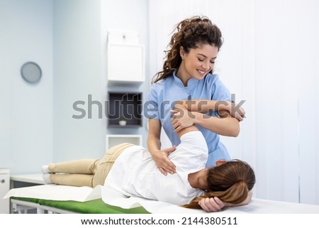 Physiotherapist treatment patient. Holding patient's hand, shoulder joint treatment. Physical Doctor consulting with patient About Shoulder muscule pain problems Physical therapy diagnosing concept Royalty-Free Stock Photo #2144380511