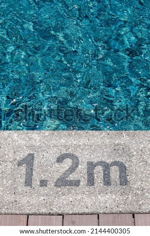 Pool depth warning sign on swimming poll side. Showing swimming pool depth of 1.2 meter. Selective focus image. Royalty-Free Stock Photo #2144400305