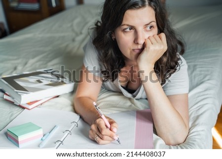 Woman, young girl writes morning pages,takes notes in personal diary of thoughts, mental health. Drawing up plans,to-do lists. Remote work at home. Student studing, making homework. Distance learning.
