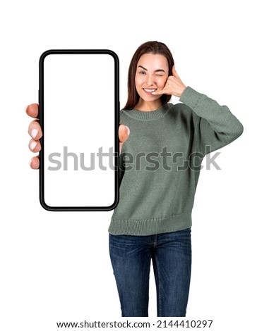 Young woman with call us hand gesture, holding phone with mockup screen, isolated over white background. Concept of support and communication