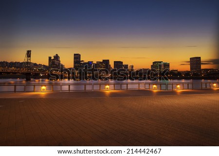 Portland, Oregon city skyline panorama with Hawthorne bridge. Colorful sunset sky and light reflection on the Willamette river.