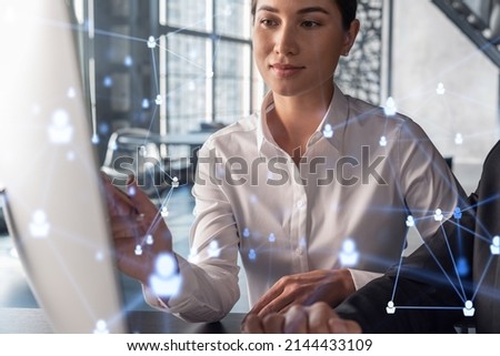 Businessman and businesswoman in formal wear working together looking for new employees to hire for international business consulting. HR, social media icons over modern panoramic office background