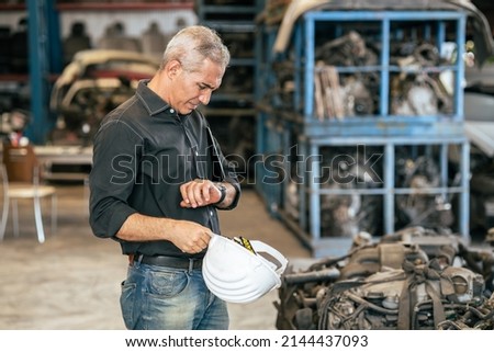 engineer male worker looking wrist watch for stress worry with working late apointment time concept Royalty-Free Stock Photo #2144437093