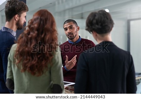 Hes the one with the best ideas. Shot of a group of businesspeople having a discussion in an office. Royalty-Free Stock Photo #2144449043