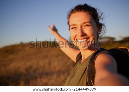 I want to share my journey with everyone. Shot of a young woman taking a selfie while out hiking. Royalty-Free Stock Photo #2144449899
