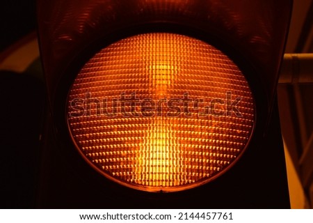 Yellow traffic light at night