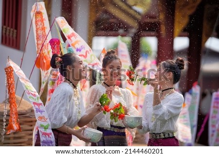 Asian Thai girls splash water in the Songkran tradition of Thai Lanna, Chiang Mai Province, Thailand